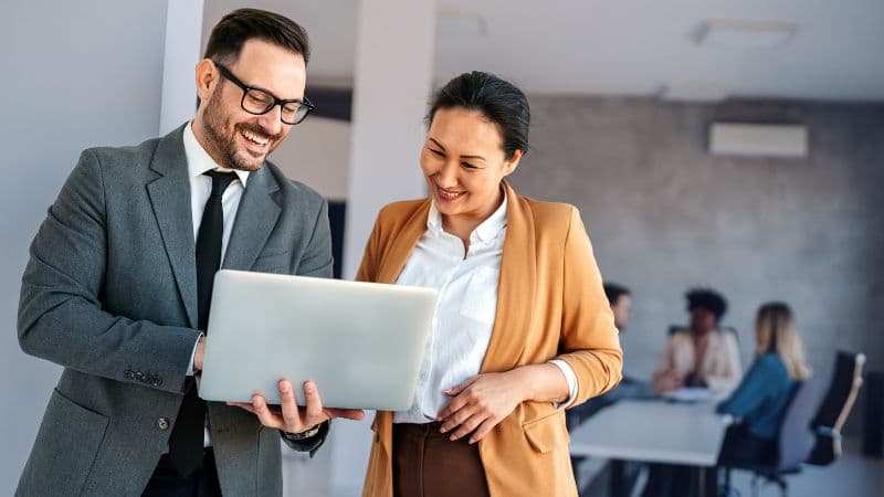 Financial Services Professionals Looking At A Laptop Together